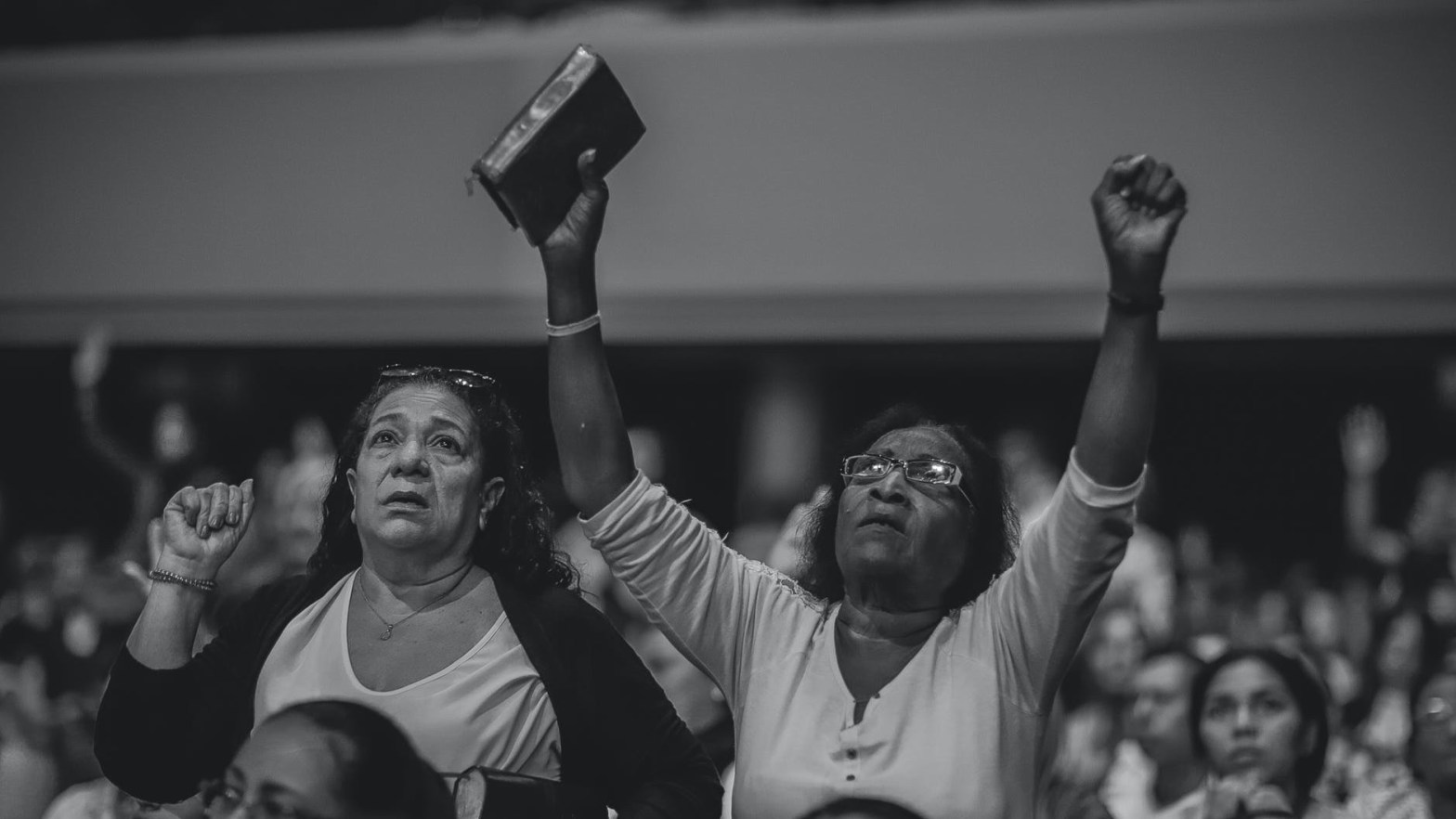 grayscale photography of people worshiping