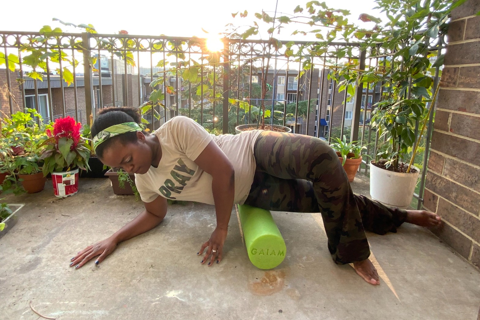Michelle using a green foam roller on the right hip
