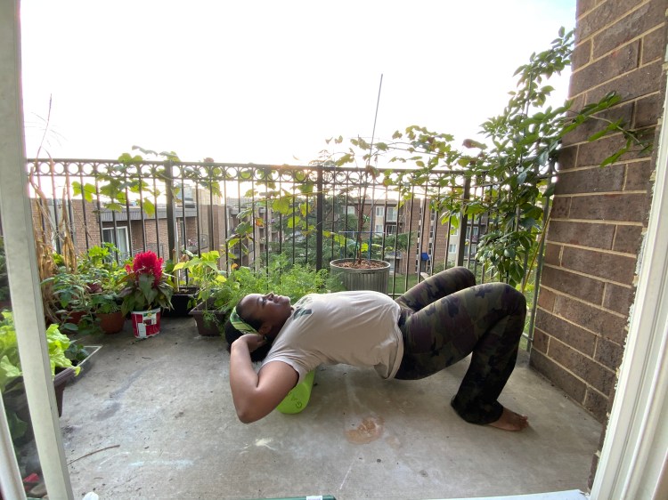 Michelle using a foam roller on the upper back