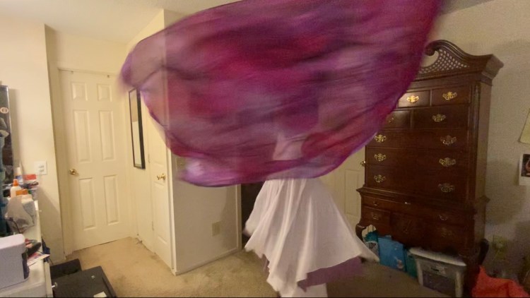 Michelle spinning with purple flags