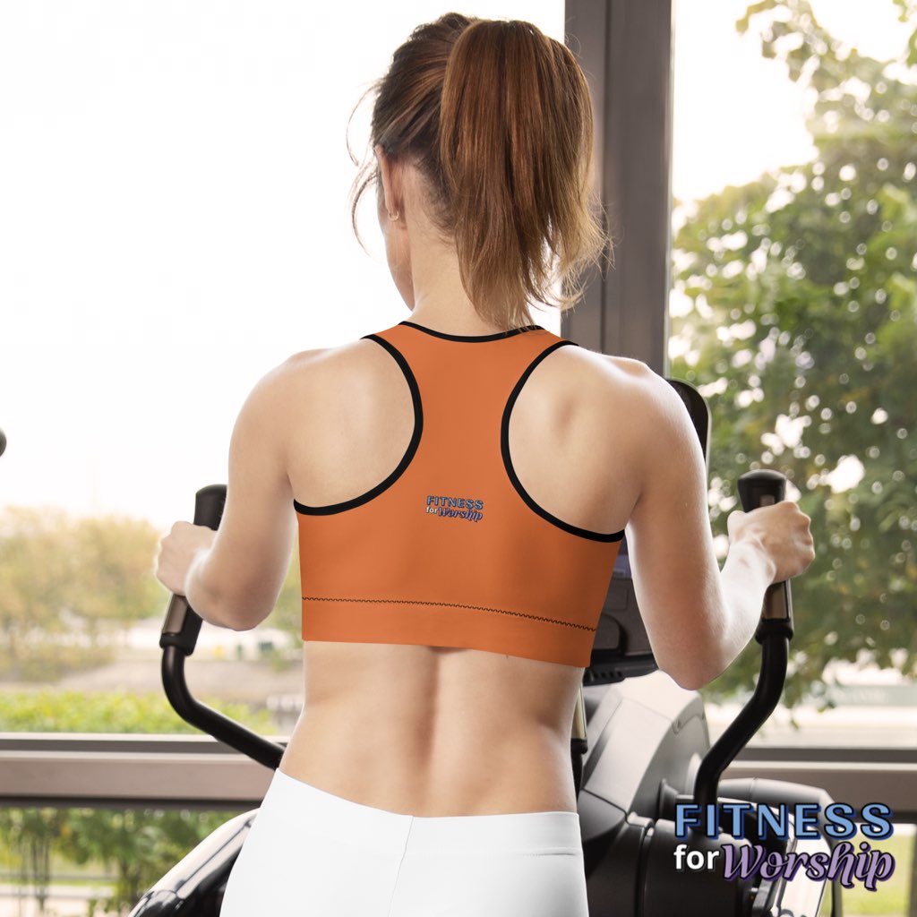 back of woman in a gym wearing HEALED Red Sports bra by Fitness for Worship