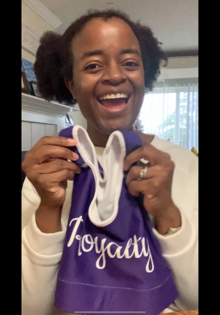 Michelle Barnes holding the purple Royalty Sports Bra