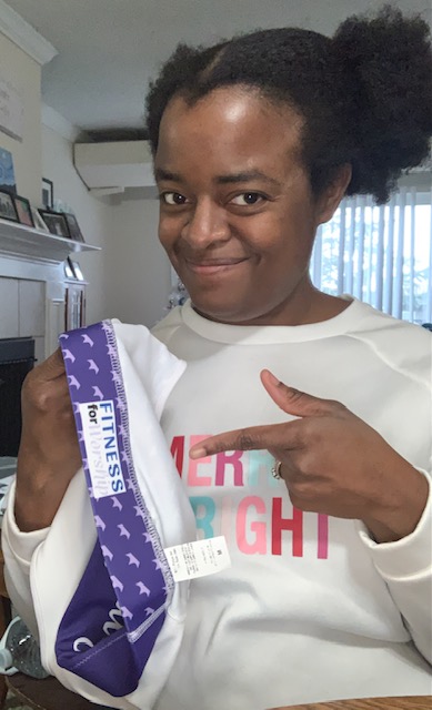 Michelle holding the purple Royalty Sports Bra