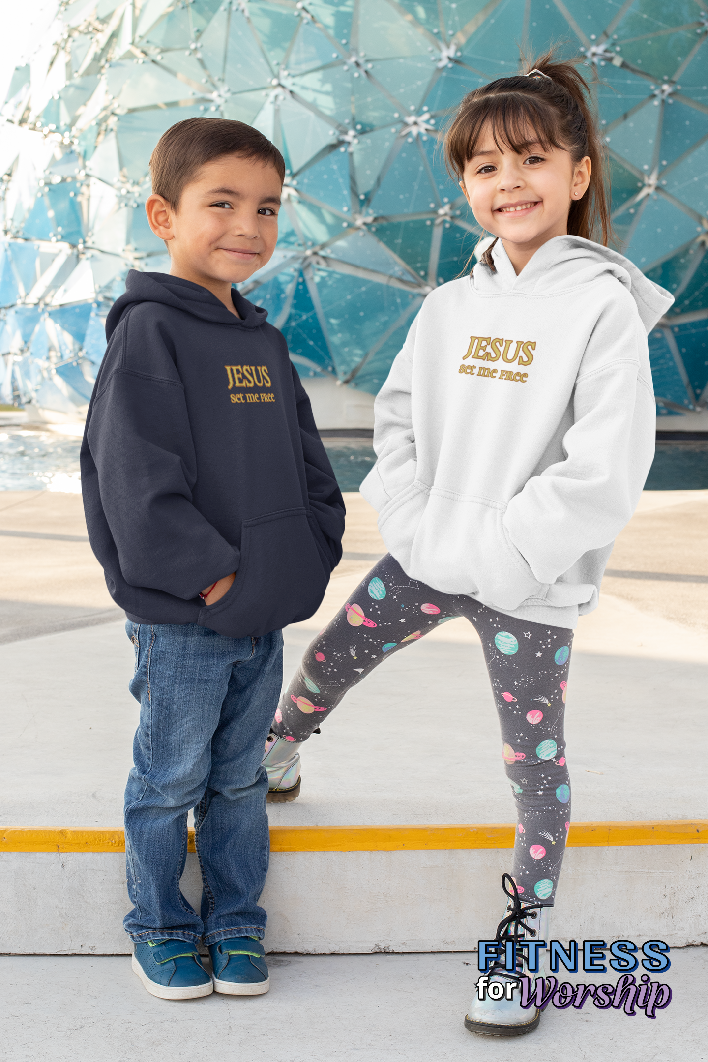 Boy and girl wearing “Jesus Set Me Free” Fleece Hoodie for Kids by Fitness for Worship in navy and white
