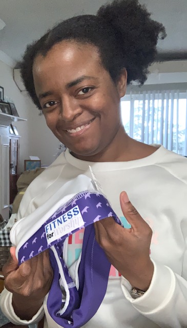 Michelle holding the purple Royalty Sports Bra