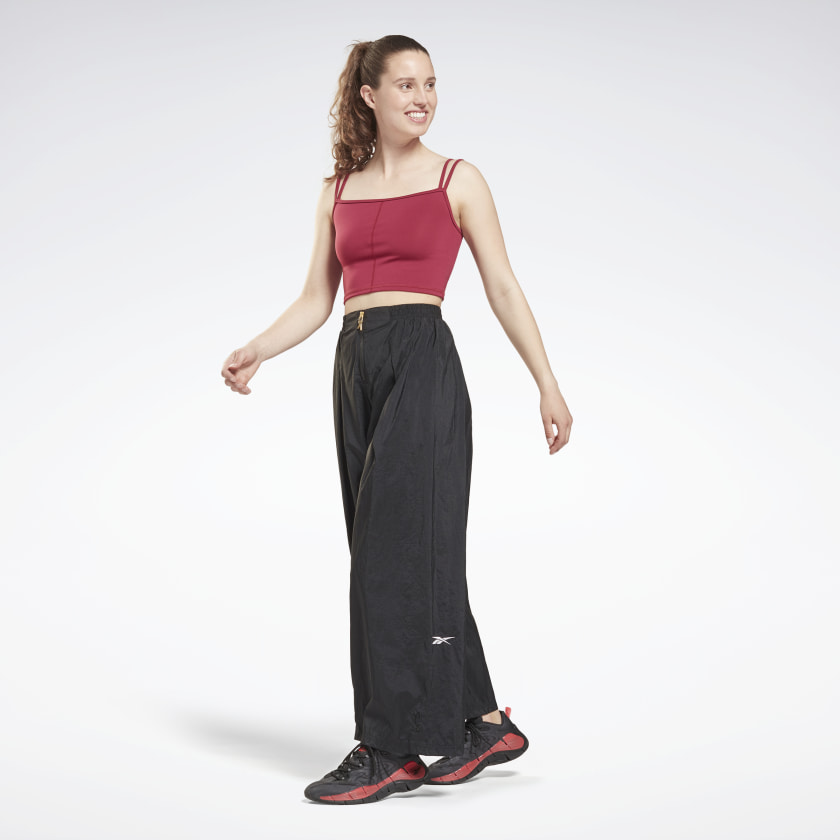 Woman wearing Reebok Studio Shiny Woven Pants