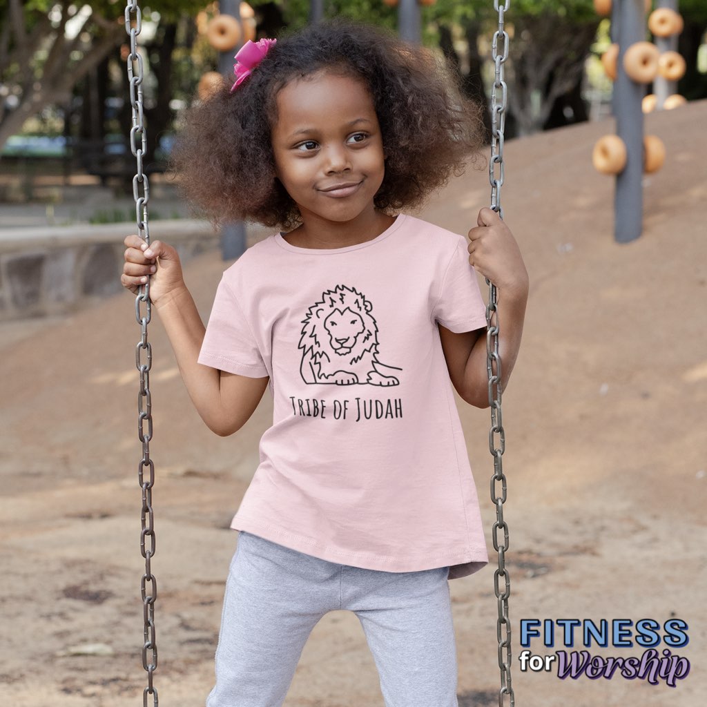 Girl in a park wearing pink Lion Tribe of Judah Short Sleeve T-Shirt for Toddlers by Fitness for Worship