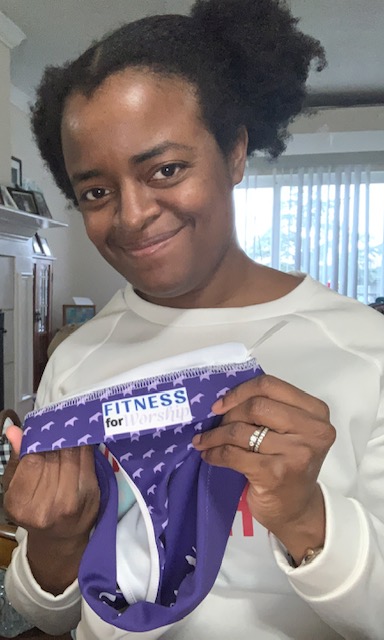 Michelle holding the purple Royalty Sports Bra